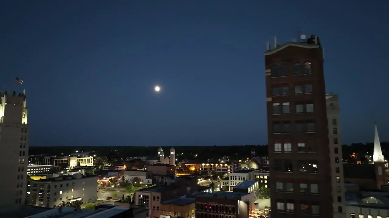 Jackson Michigan downtown at night with drone video close up with moon moving right to left