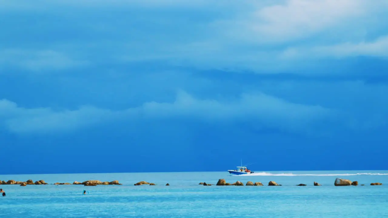 Boat rushing back to shore in calm before storm Curacao Caribbean Sea