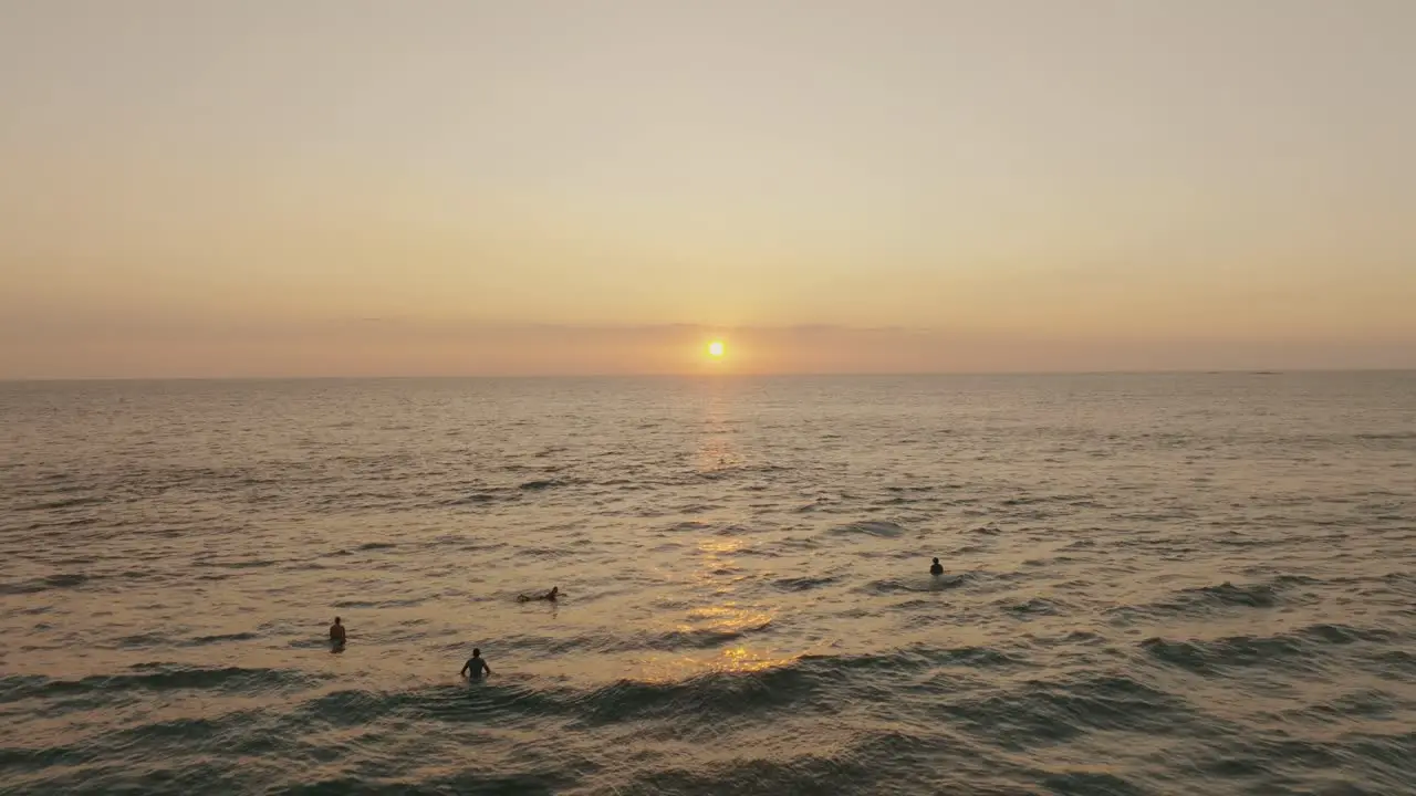 People In The Ocean By Sunset In Guanacaste Costa Rica aerial drone shot