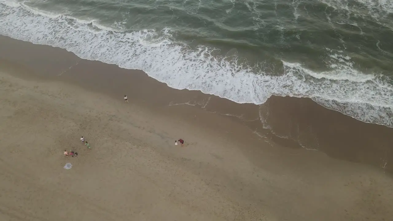 Father and son play running on beach Playa La Viuda in Uruguay