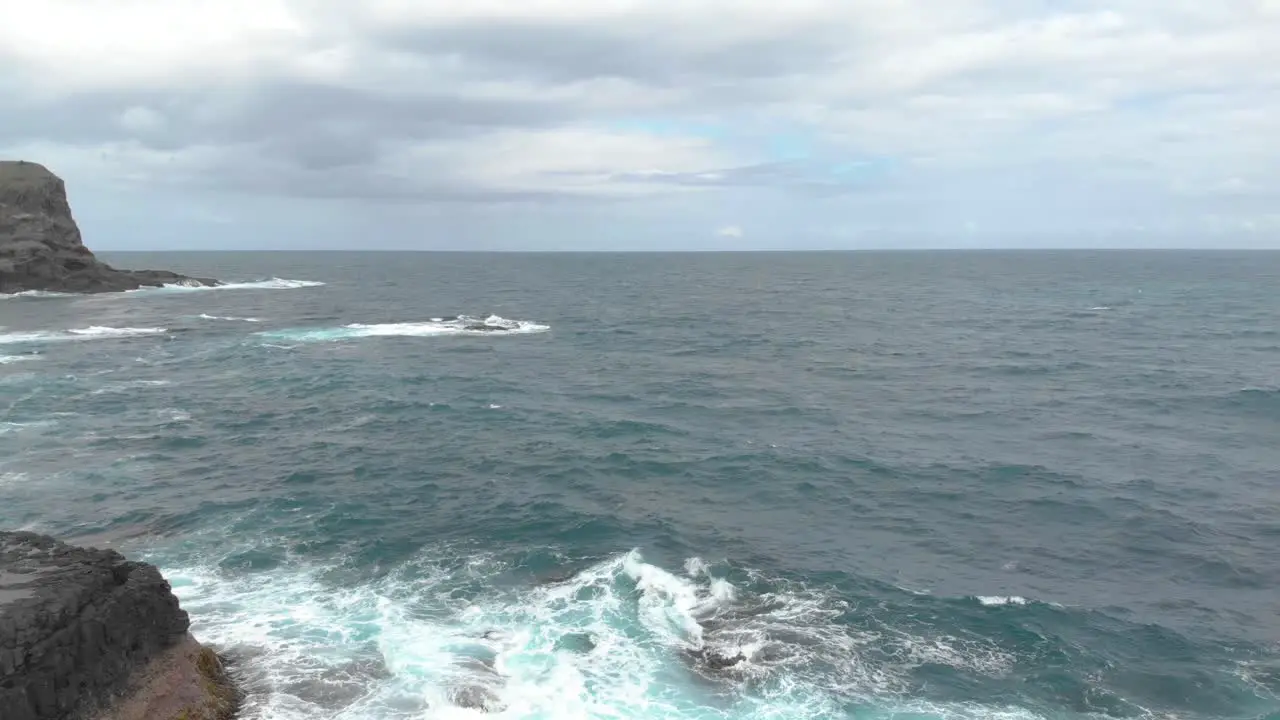 Forward moving aerial shot over wild oceans by the rocks and cliffs of Mornington Peninsula Victoria