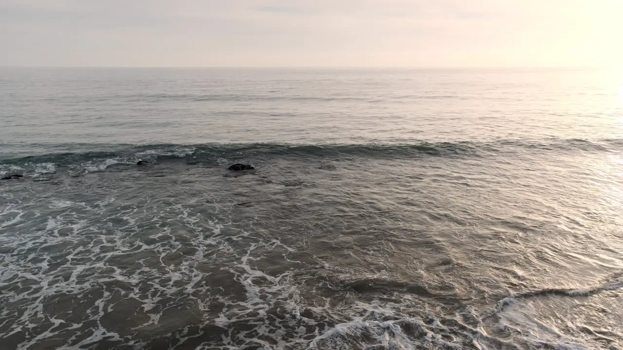 Reminiscing on the shoreline beach of Big Rock Malibu California at soothing golden hour