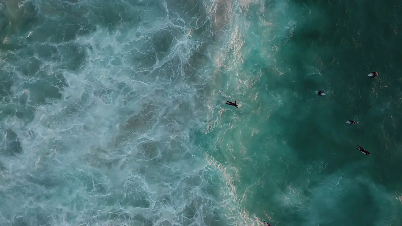 A Surfer Lying on a Surfboard Swimming to Join His Friends Waiting for a Big Wave to Ride in Llandudno Cape Town Overhead Fixed Shot