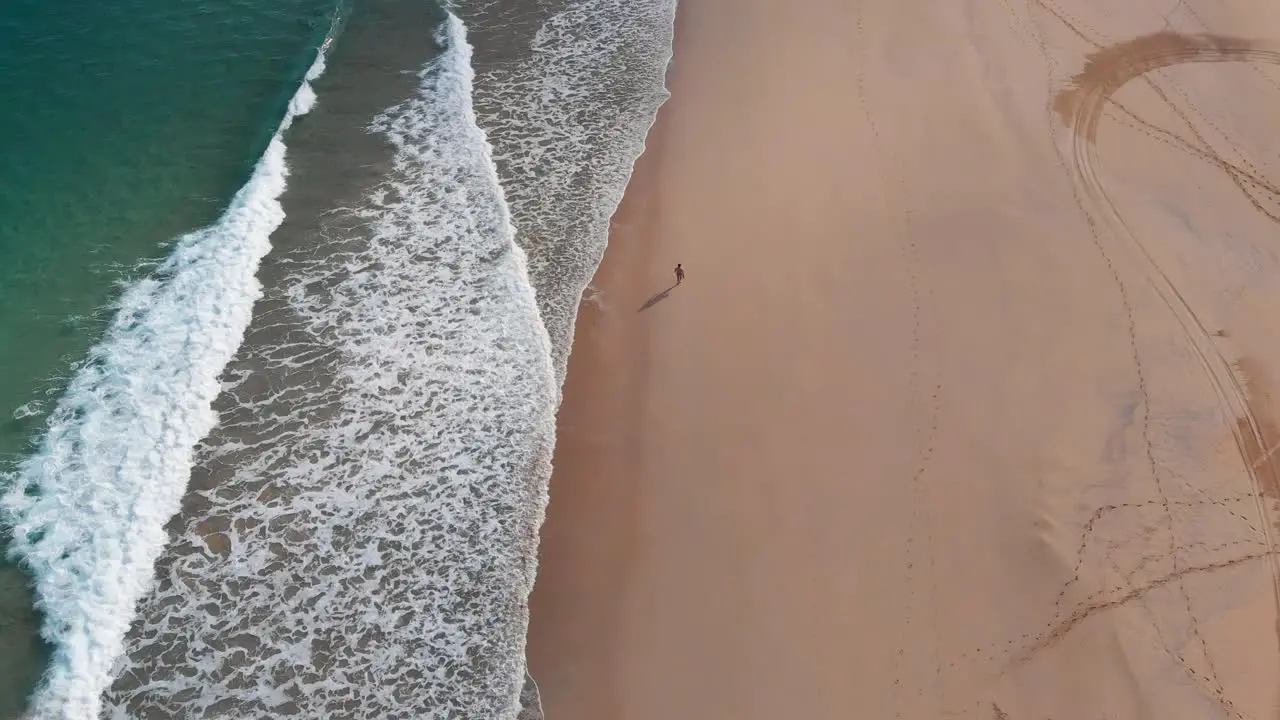 One person walks alone on golden beach at Porto Santo island Portugal