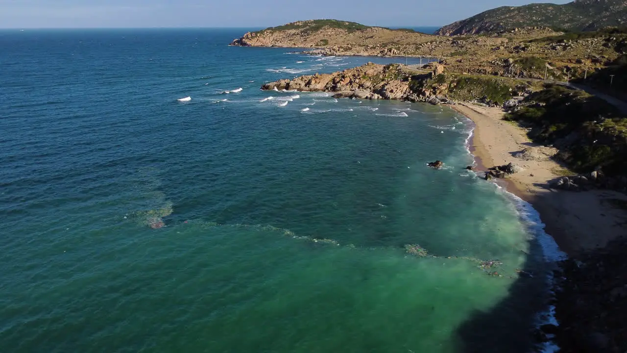 Beach coast with plastic ocean trash lined across current