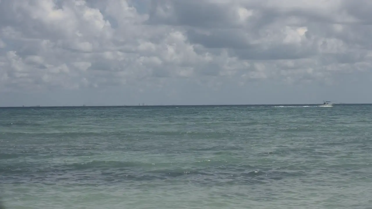 Static shot of motor boat sailing on the sea on cloudy day