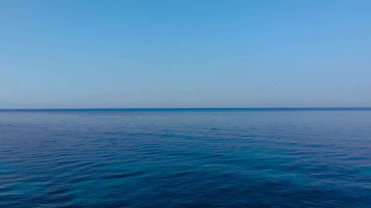 Blue azure water of open sea and clear bright sky at summer sunny day copy space for vacation texture