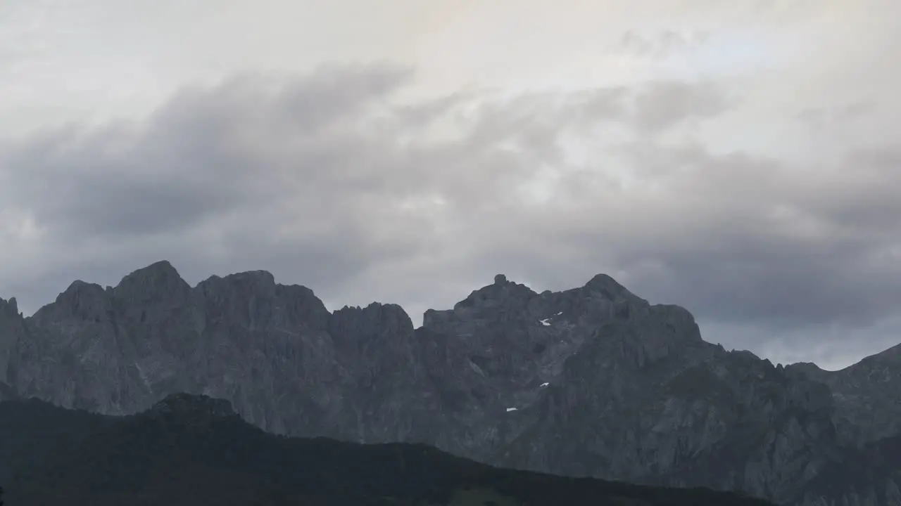 Gloomy clouds floating over mountain ridge