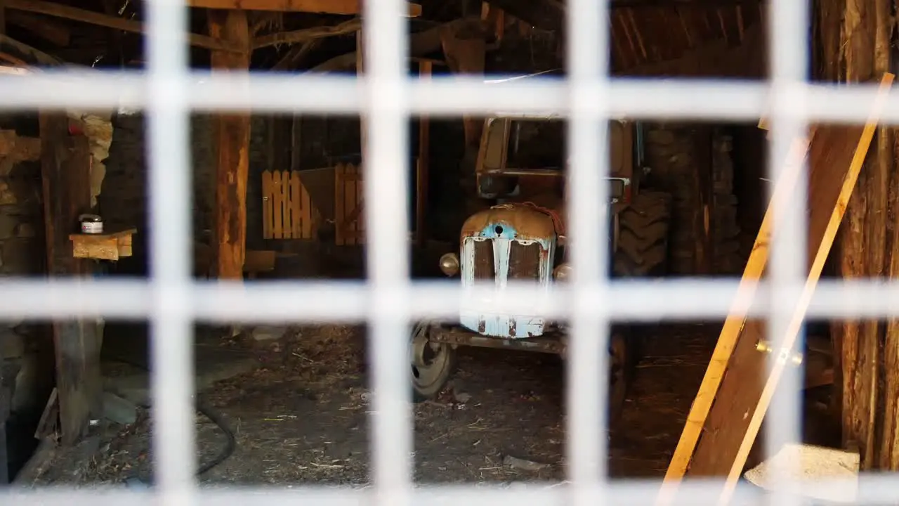 Abandoned tractor in a barn