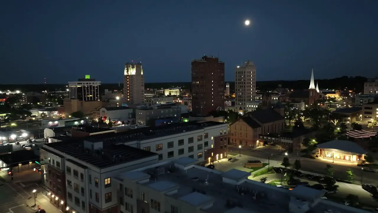 Jackson Michigan downtown at night with drone video wide shot at an angle moving in