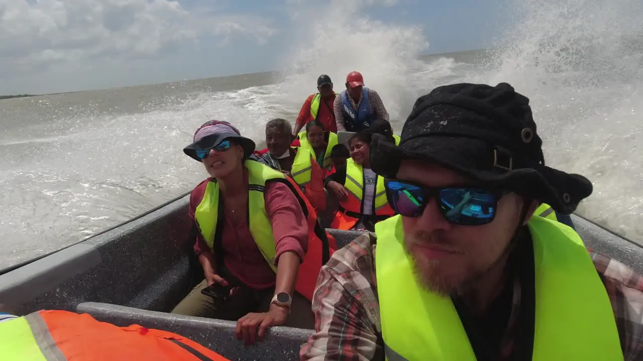 Dynamic POV Tourists enjoy rough boat ride on choppy grey ocean