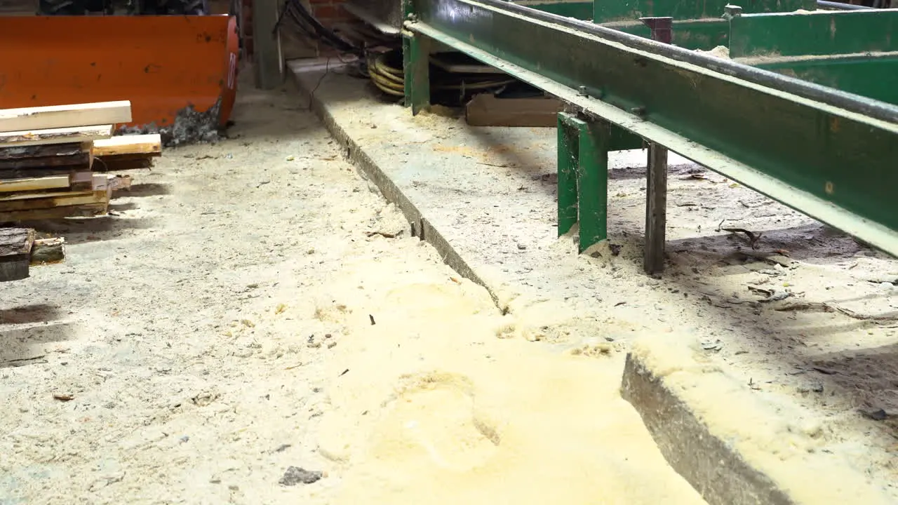 Sawdust and dirty floor in sawmill handheld dolly out