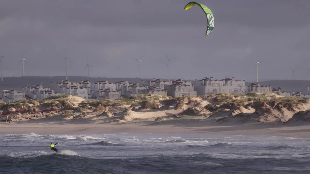 Kiteboarding on waves of Atlantic ocean in slow motion stable copyspace cinematic view