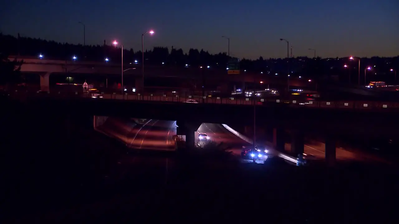 CARS ON BRIDGES DRIVING OVER FREEWAY AT NIGHT