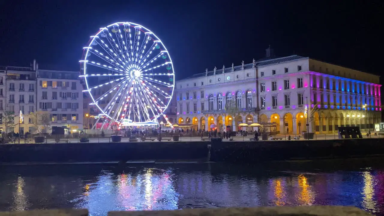 an impressive view of the Ferris wheel in the beautiful city of Bayona illuminated by Christmas lights