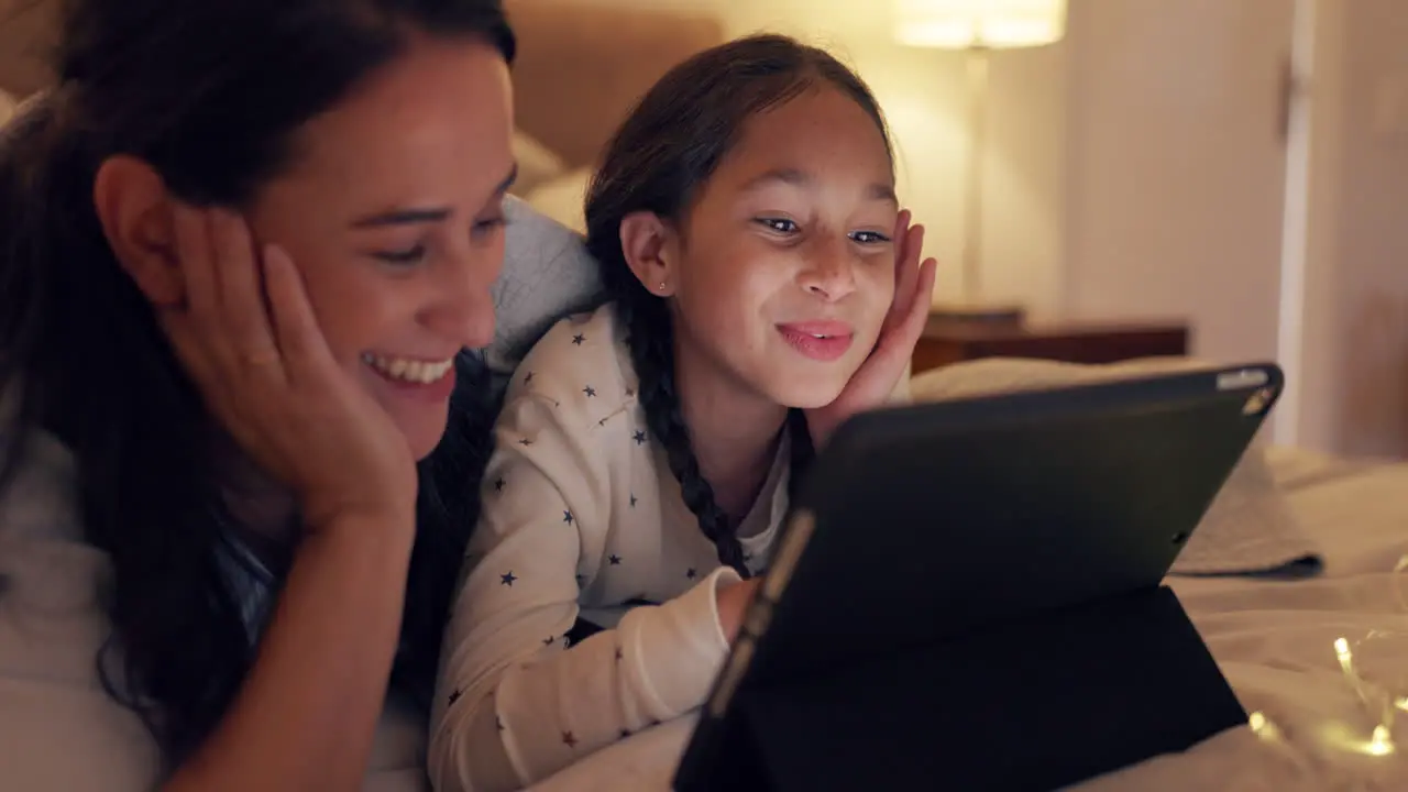 Tablet mom and child in bed for movie night