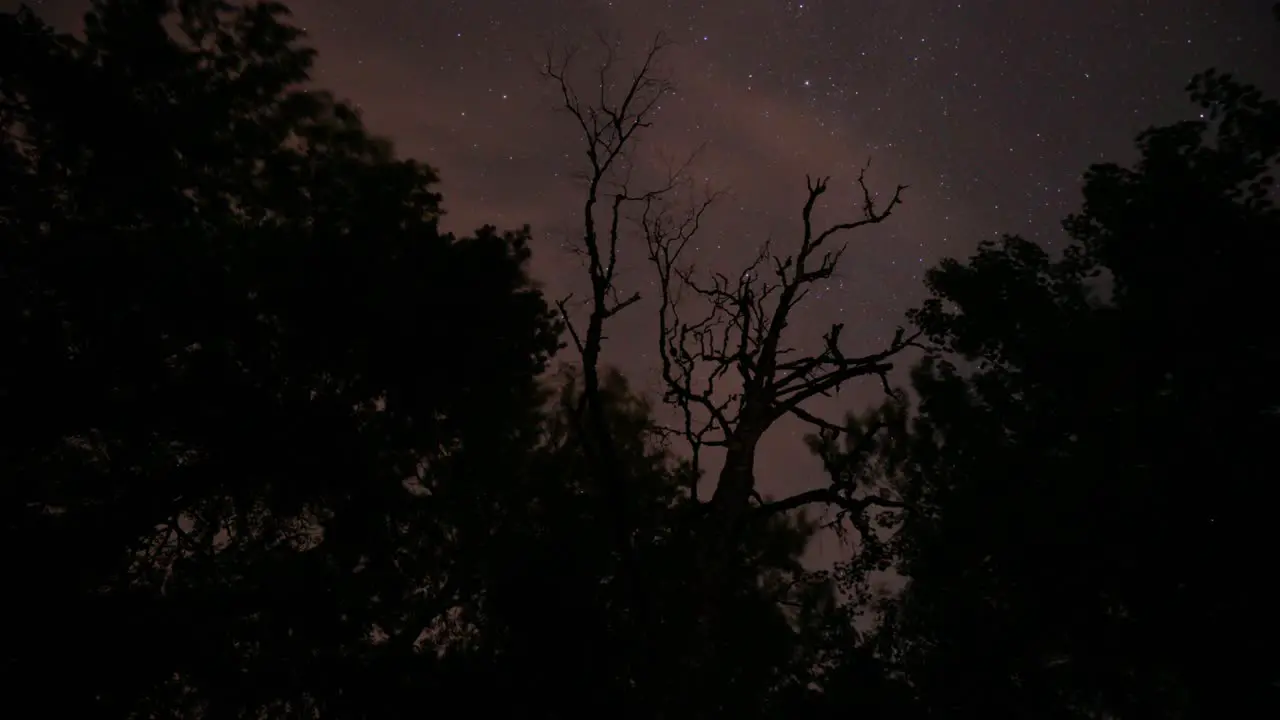 Cloudy and Dark Time Lapse of the Night Sky with Moving Stars Outdoors