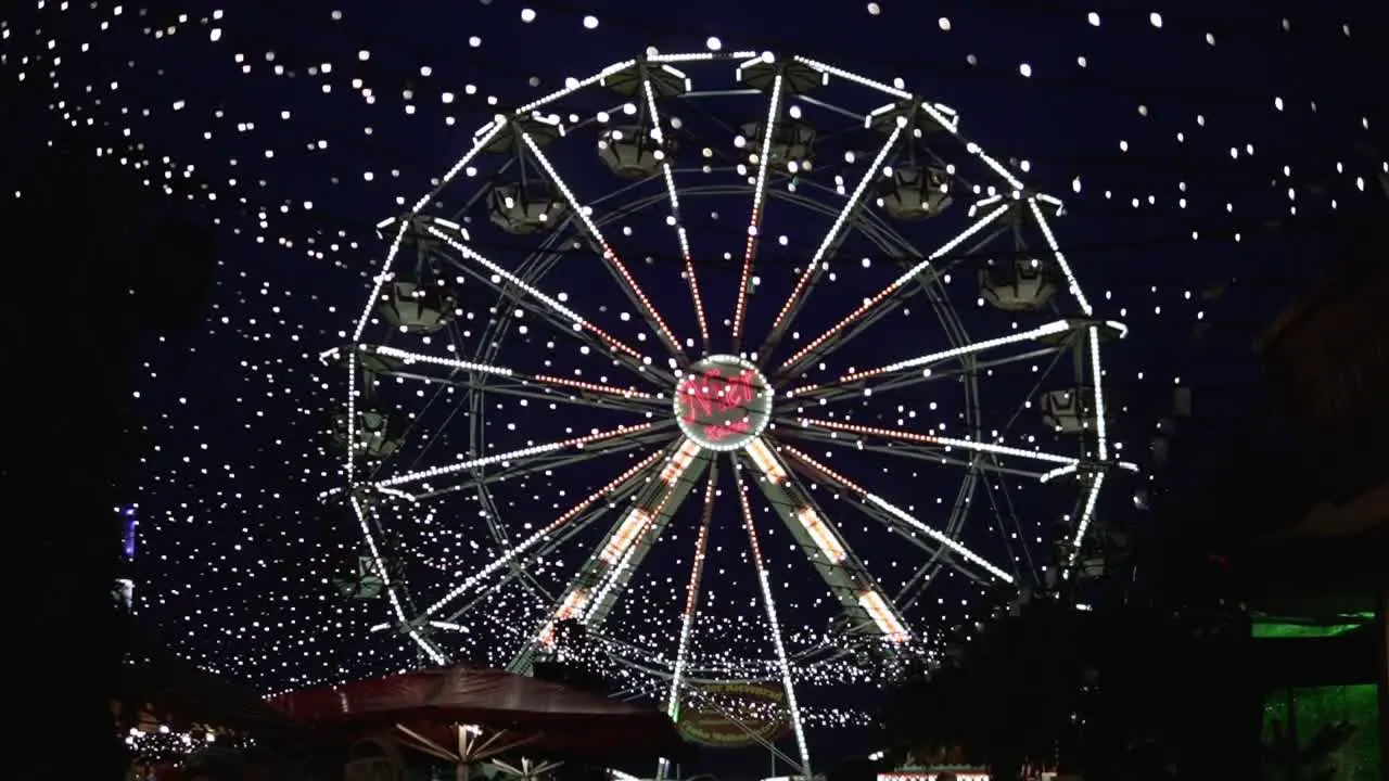 Fun fair at a christmas amrket in kassel Germany with a ferris wheel turning during tight time