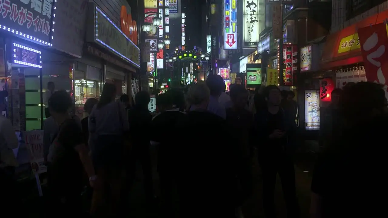 Western tourists and locals check out the restaurant quarter in the commercial center of the city at night