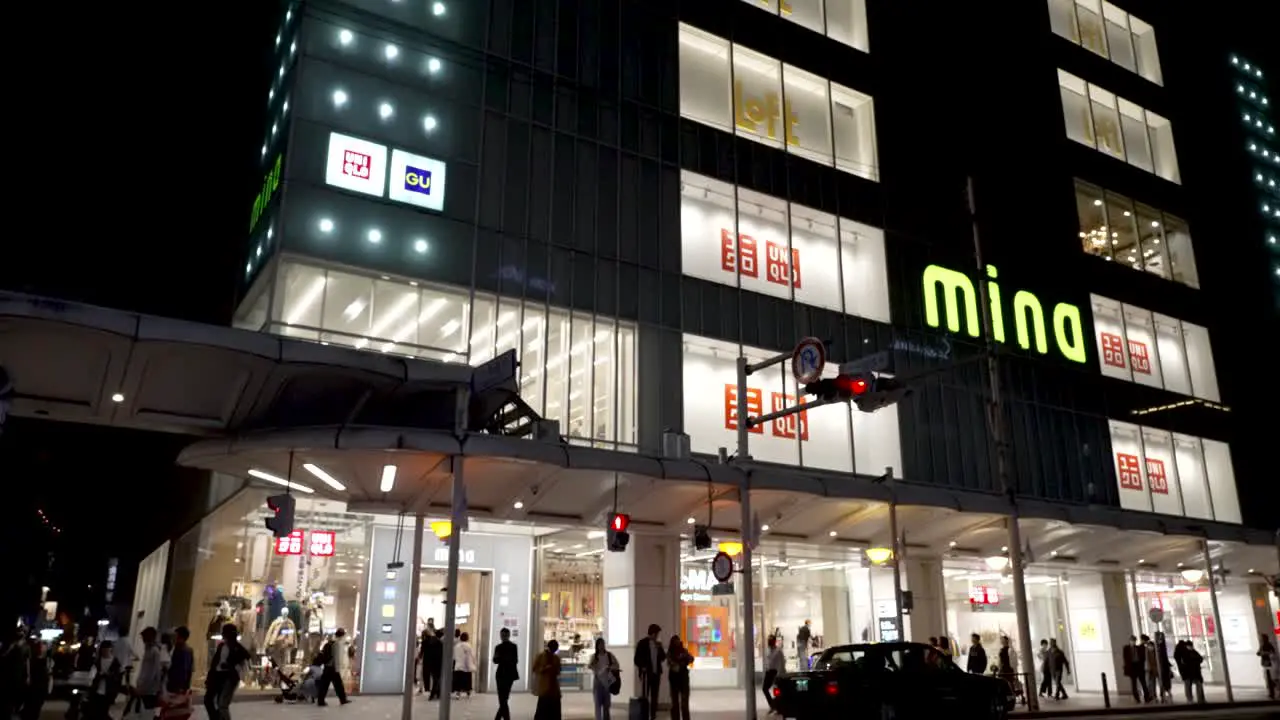 People walking in and out the Mina Kyoto Mall building during night time