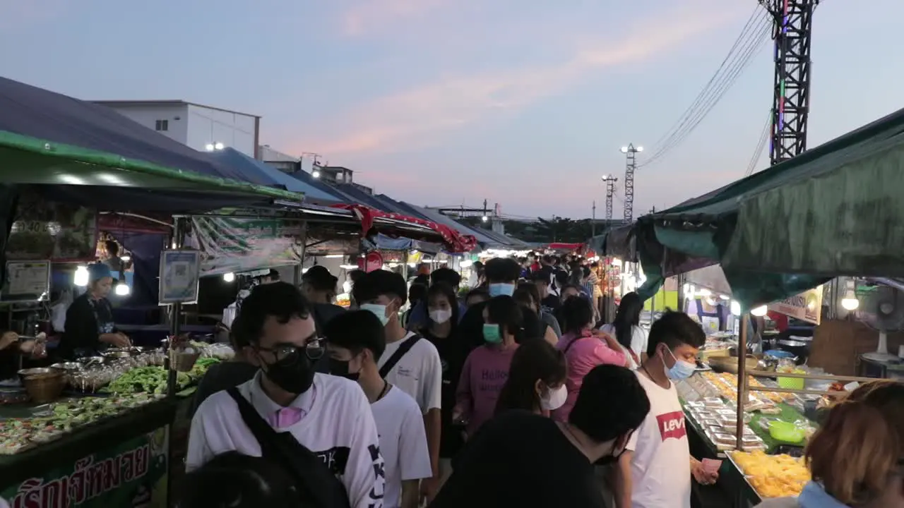 Crowd Of People Wearing Masks At Street Food Night Market At Sunset In Rayong Thailand