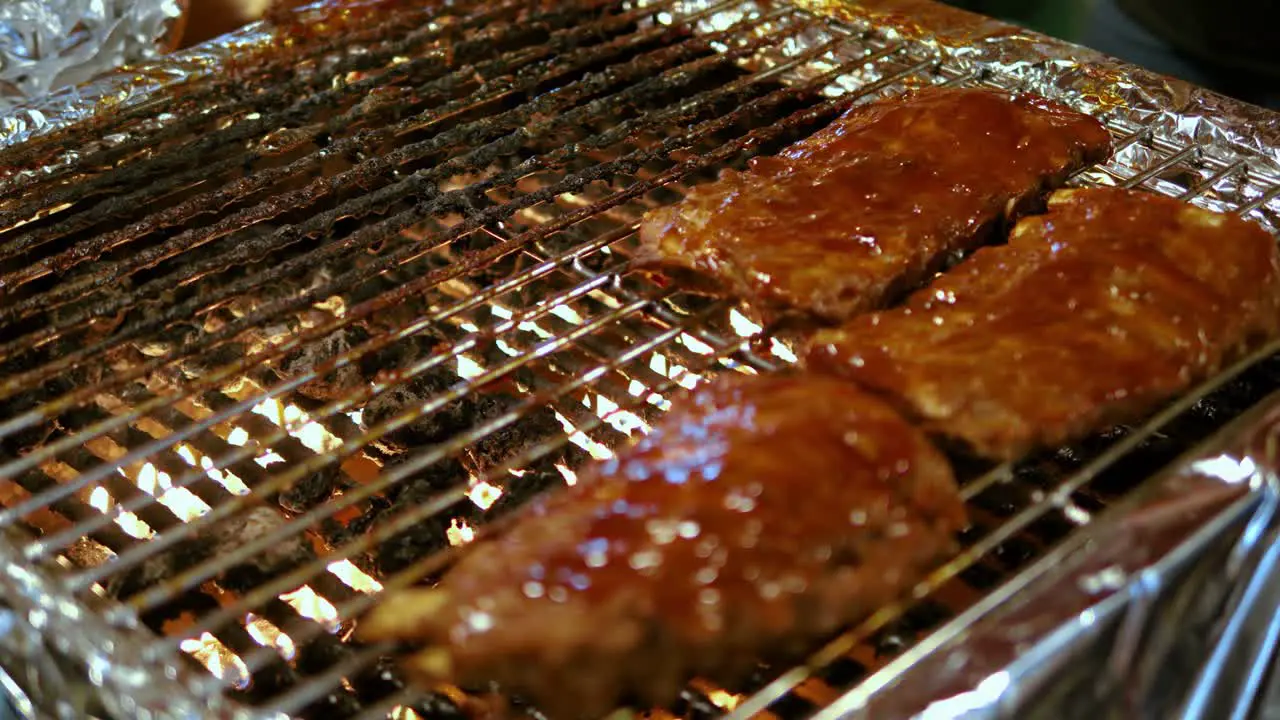 Close up Ribs with sauce on barbecue grill food night market Bangkok