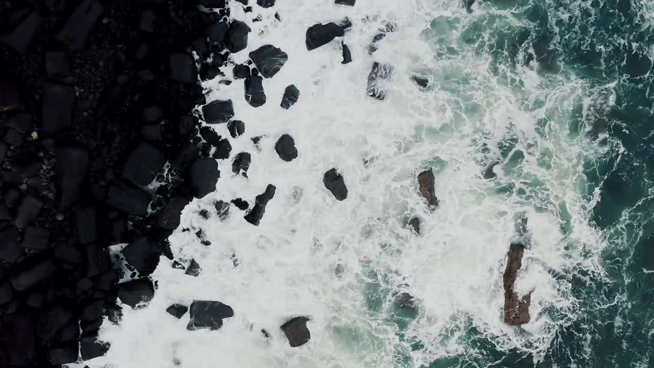 Cinematic Top Down Aerial of Ocean Sea Waves Crashing on Rocky Coast