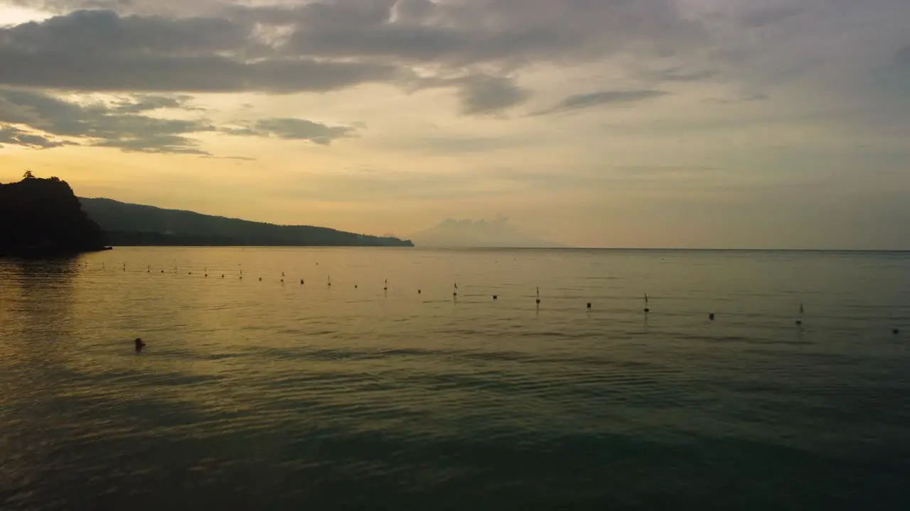 Man jogging on the shore on a sunset