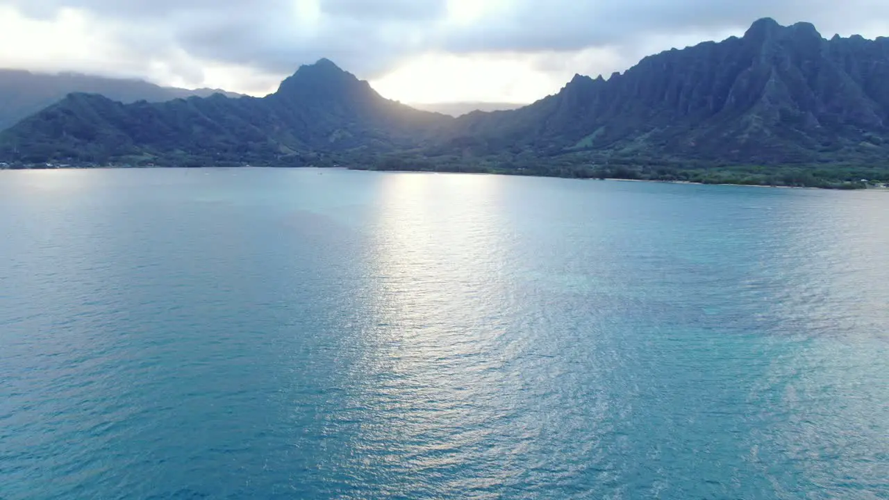 Aerial Dolly Forward Showing The Vast Mountain Range Surrounding Ocean Bay