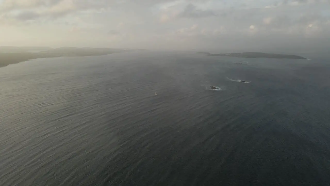 A lonely sailboat on its way to harbor in very stormy weather