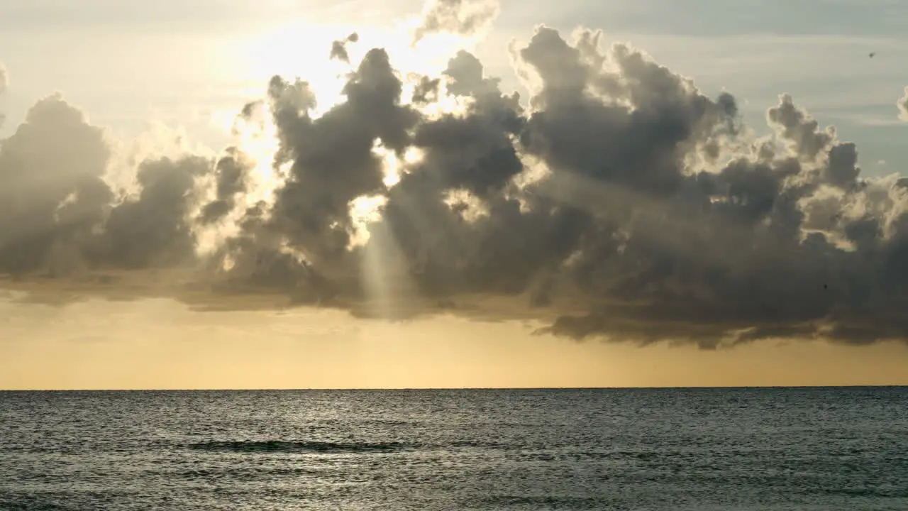 Beautiful natural view of rays of light through the clouds on a sunset in Florida beach overlooking the horizon and the sea