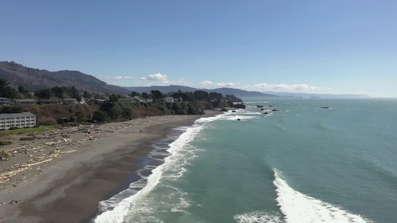 Scenic View Of Turquoise Aqua Colored Ocean With Waves Washing Shore In Brookings Oregon aerial drone shot