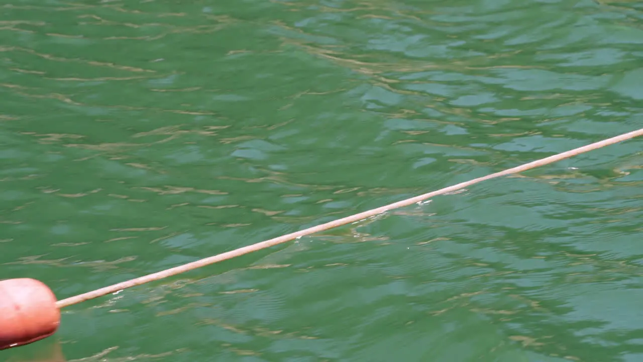 View From A Sailing Boat Of Orange Buoys With Rope Floating In The Sea high angle tracking shot