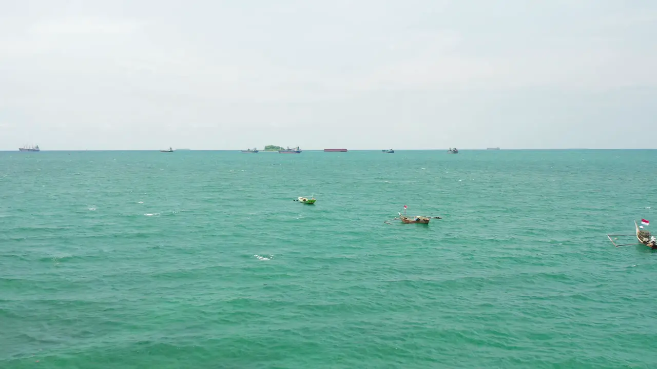 Crystal clear waters of the Indian ocean off the coast of Indonesia dotted with boats