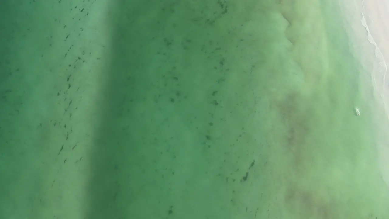 Aerial view of the ocean between the beach and the sandbar