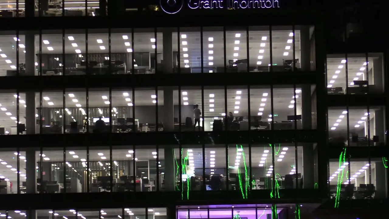 Zooming out shot of a window with people talking in an office in the heart of Dublin's financial district Dublin Grant Thornton head office and the river Liffey