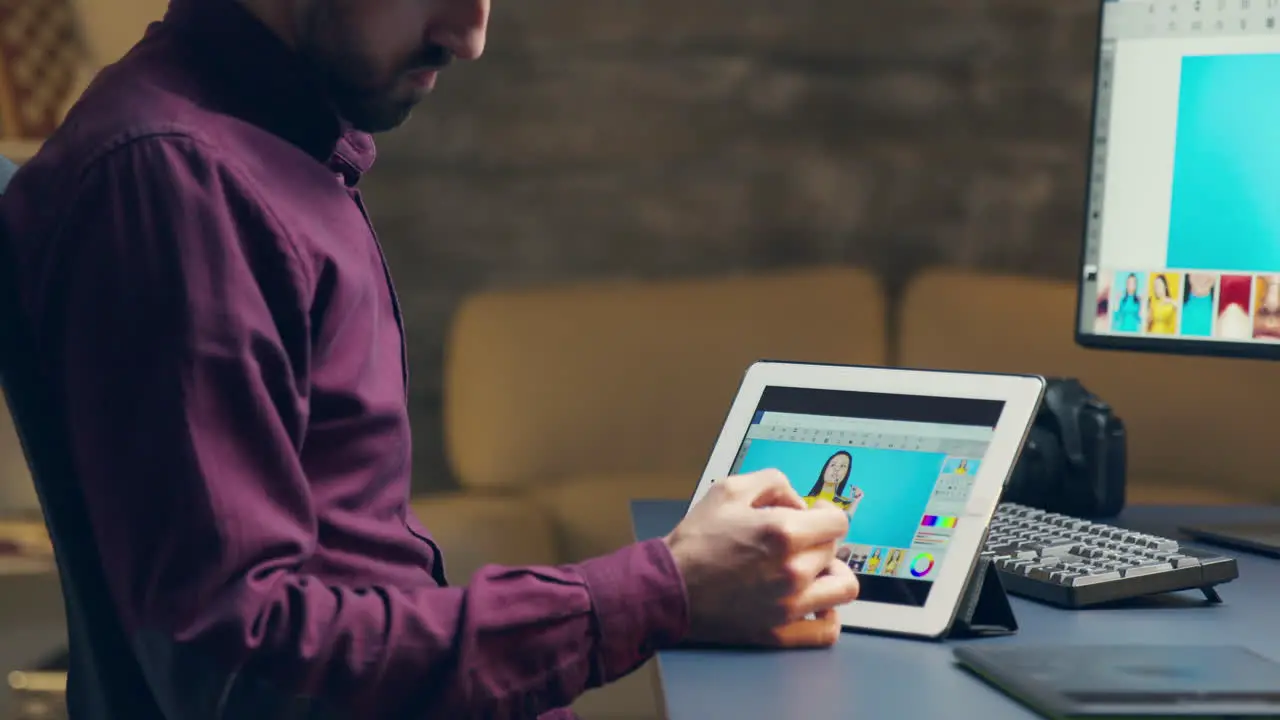 Young photographer using pen to retouch photos on tablet computer