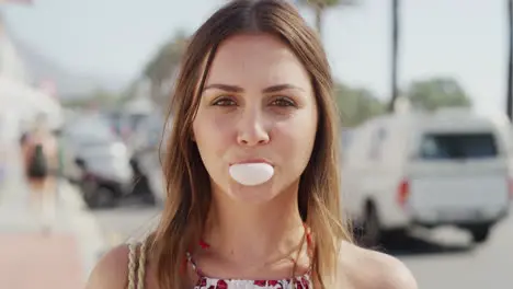 Face portrait and woman blowing bubblegum