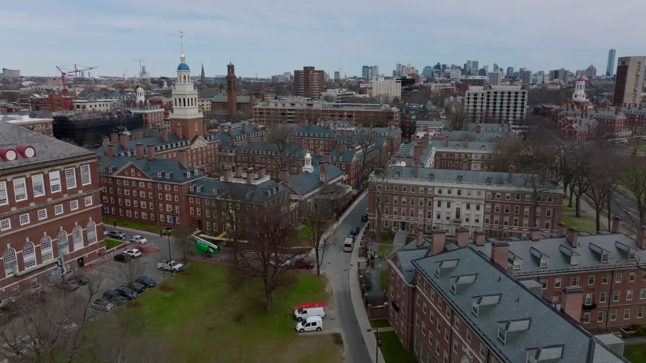 Forwards fly above buildings with red brick style facades Aerial view of Harvard University campus complex Boston USA