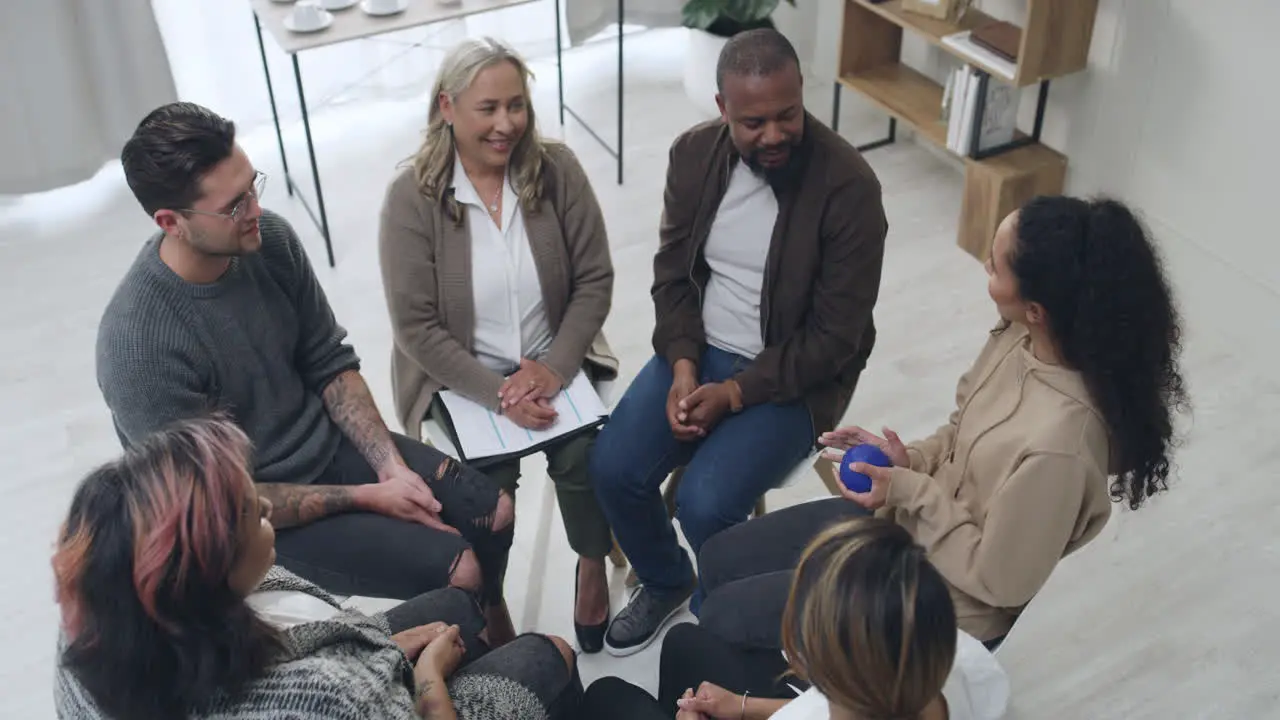 Group of diverse people passing a blue squeeze