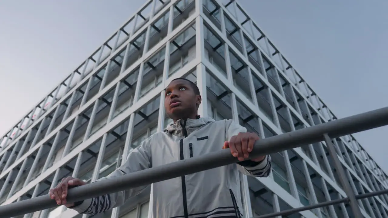 Young Black Runner Man Leaning On A Railing Outdoors