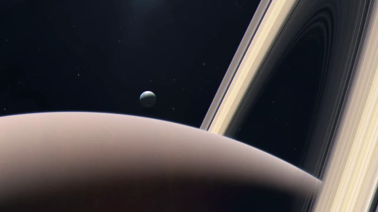 Saturn's Moon Enceladus Rising From Behind the Gas Giant Planet