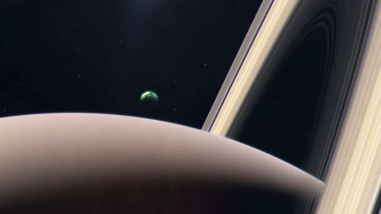 Saturn's Moon Titan Rising From Behind the Gas Giant Planet