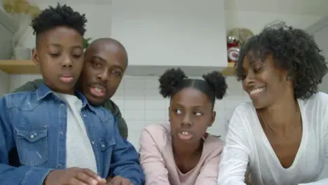 Joyful Family Talking Directly into Webcam During a Video Call