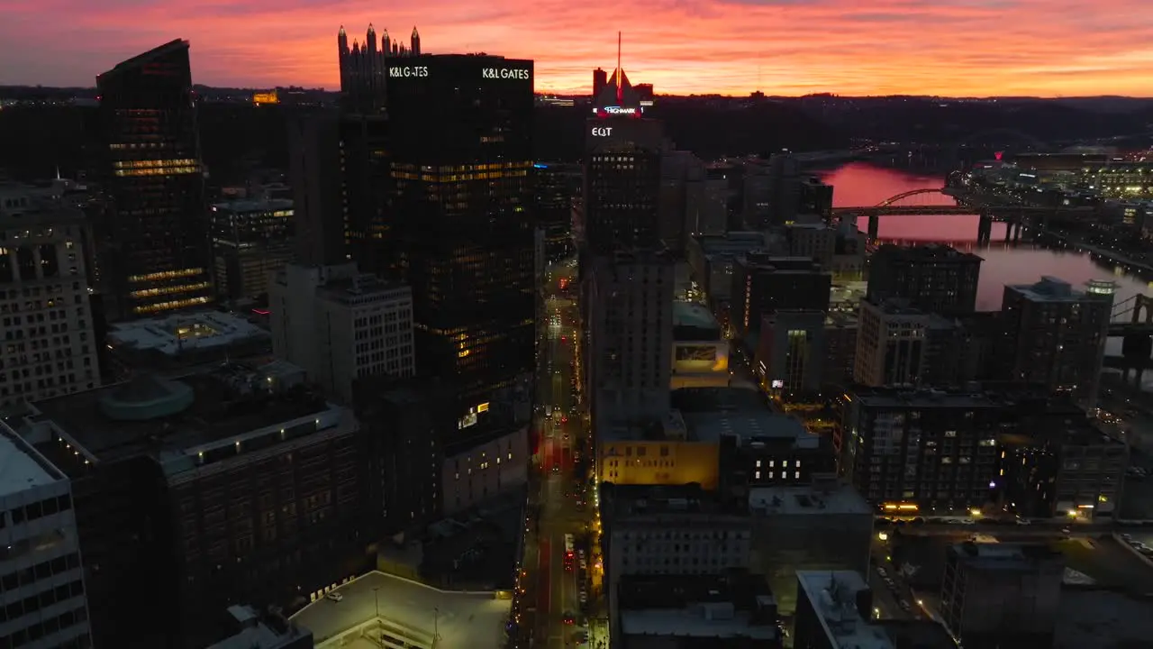 Aerial descending shot into downtown city at sunset