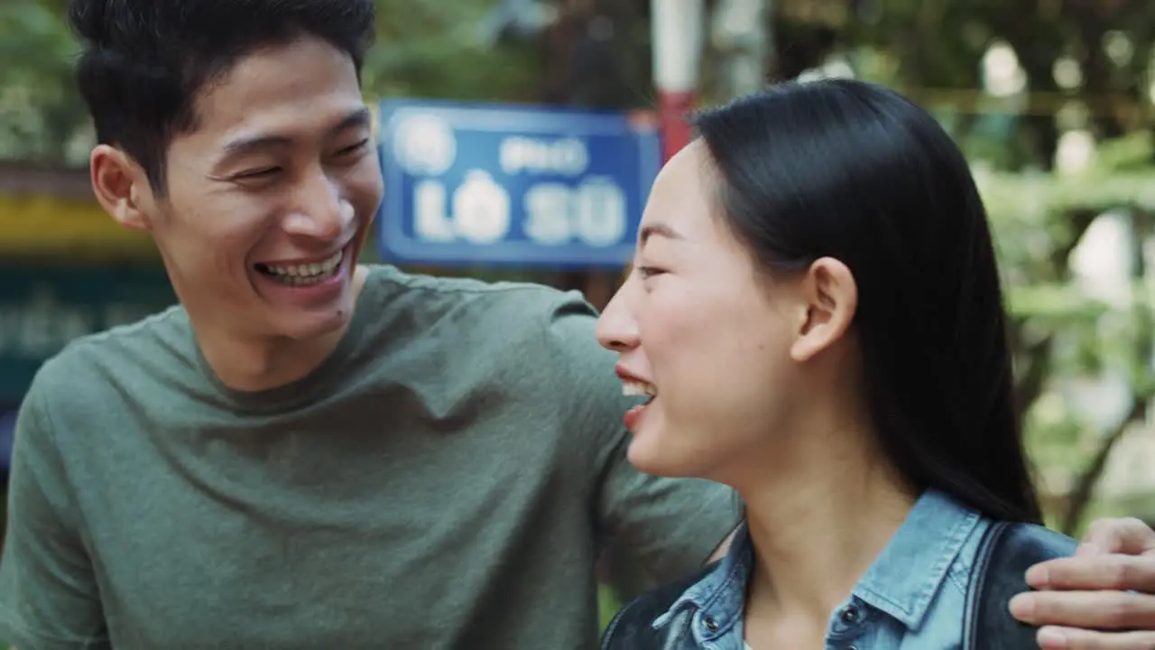 Handheld view of Vietnamese couple walking in the city