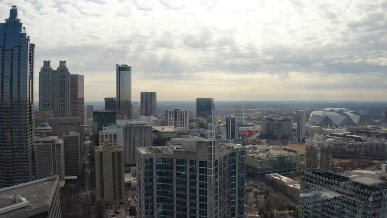 Slow moving aerial drone shot flying above the skyscrapers in downtown Atlanta Georgia on a cloudy day in the winter