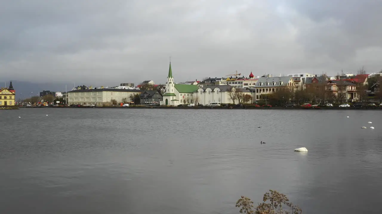 Busy scene in Reykjavik Iceland panning drone shot from coastline