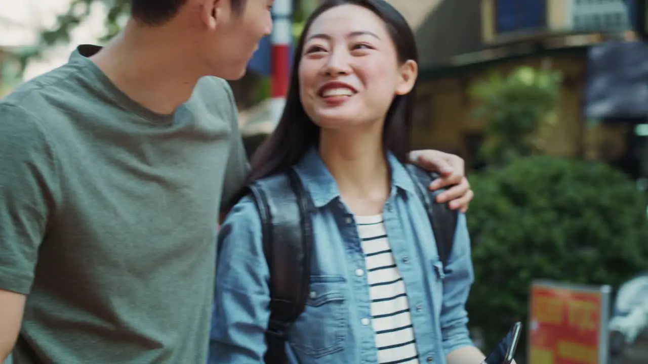 Handheld view of Vietnamese young couple in the city