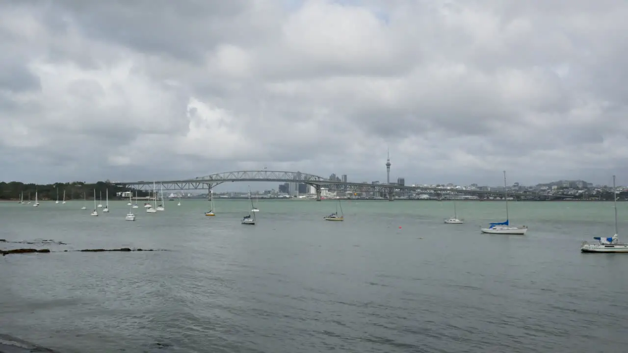 Timelapse Overlooking Auckland with Yachts and City Harbour Bridge in the Background on a Cloudy Day in New Zealand